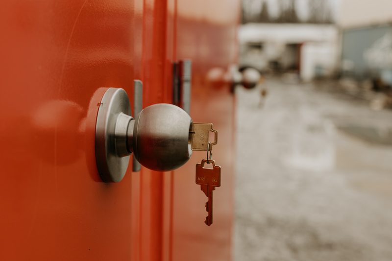 Close-up of a secure keyed door lock on a restroom unit