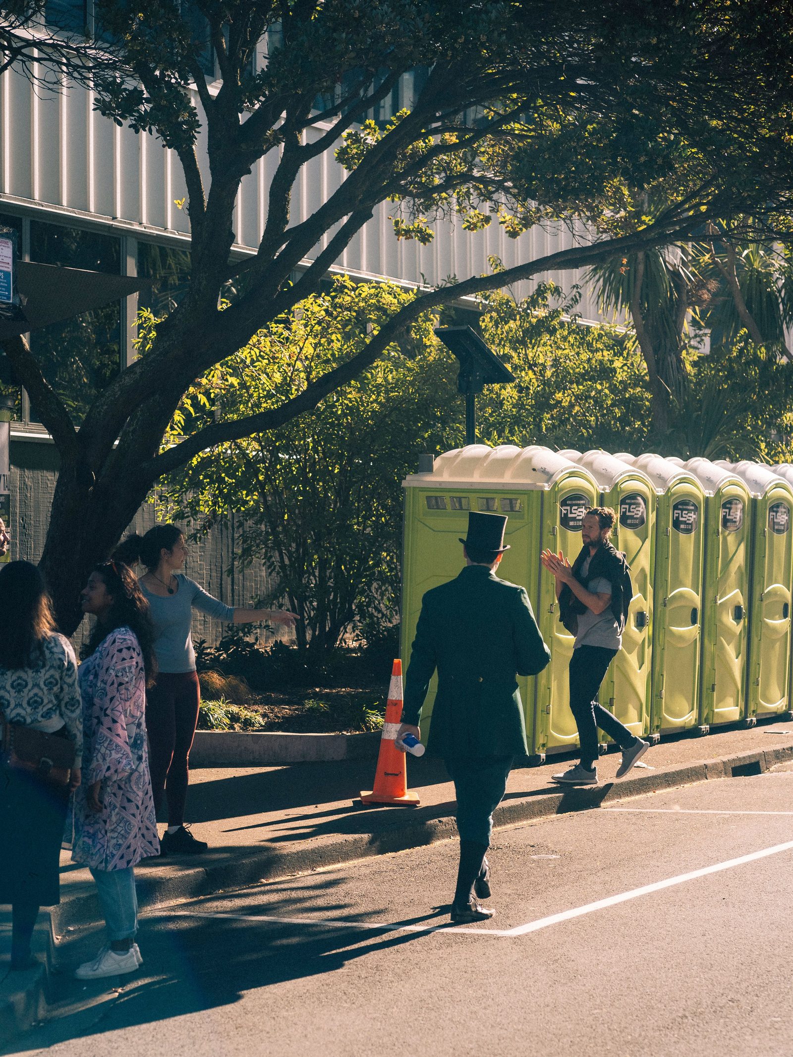Row of orange portable restrooms staged at a public event